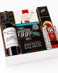 Gift basket with mark ryan wine, cookies, smoked salmon, and crackers on a marble surface